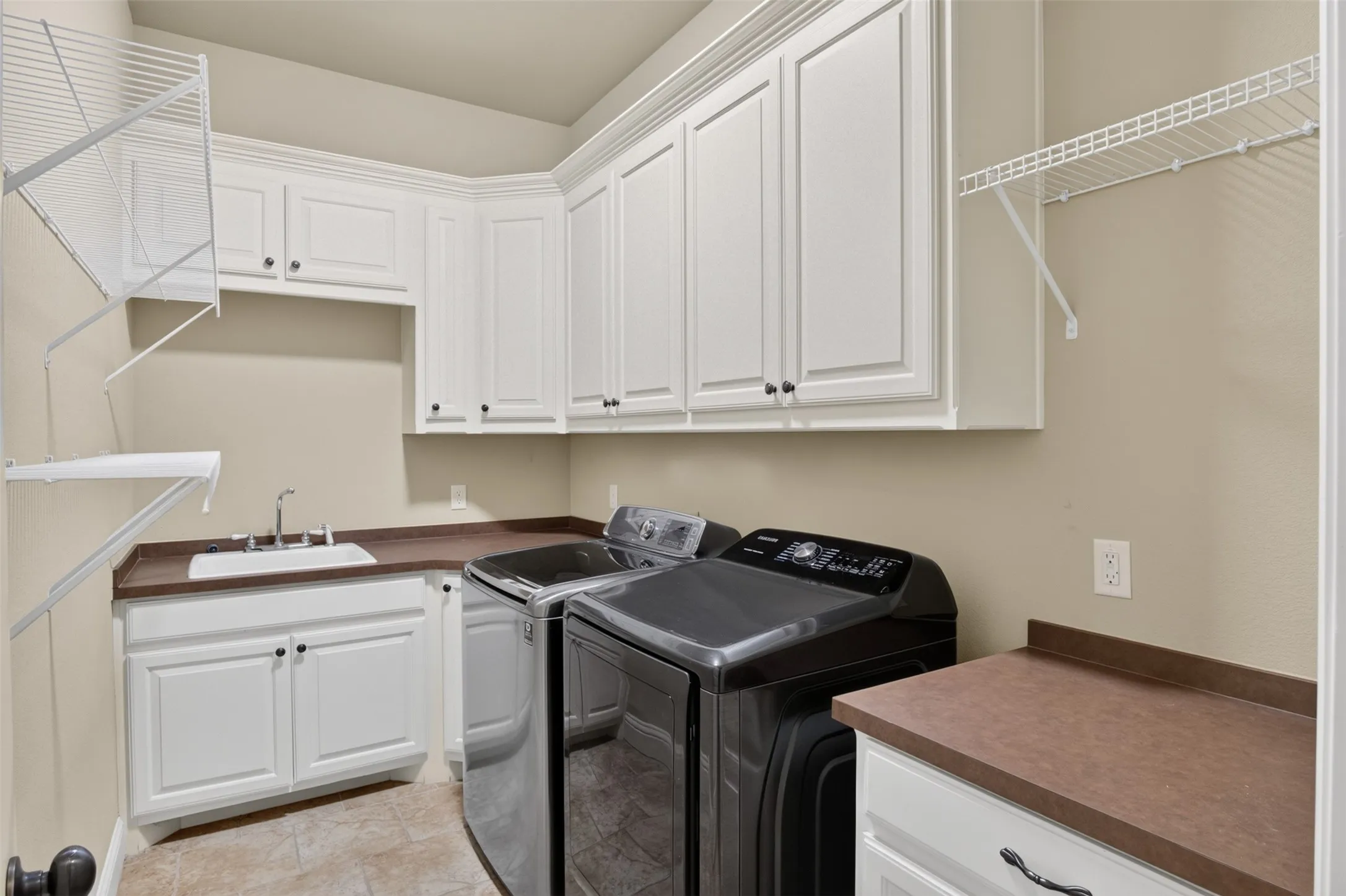 White cabinetry, integrated sink, and countertops for folding