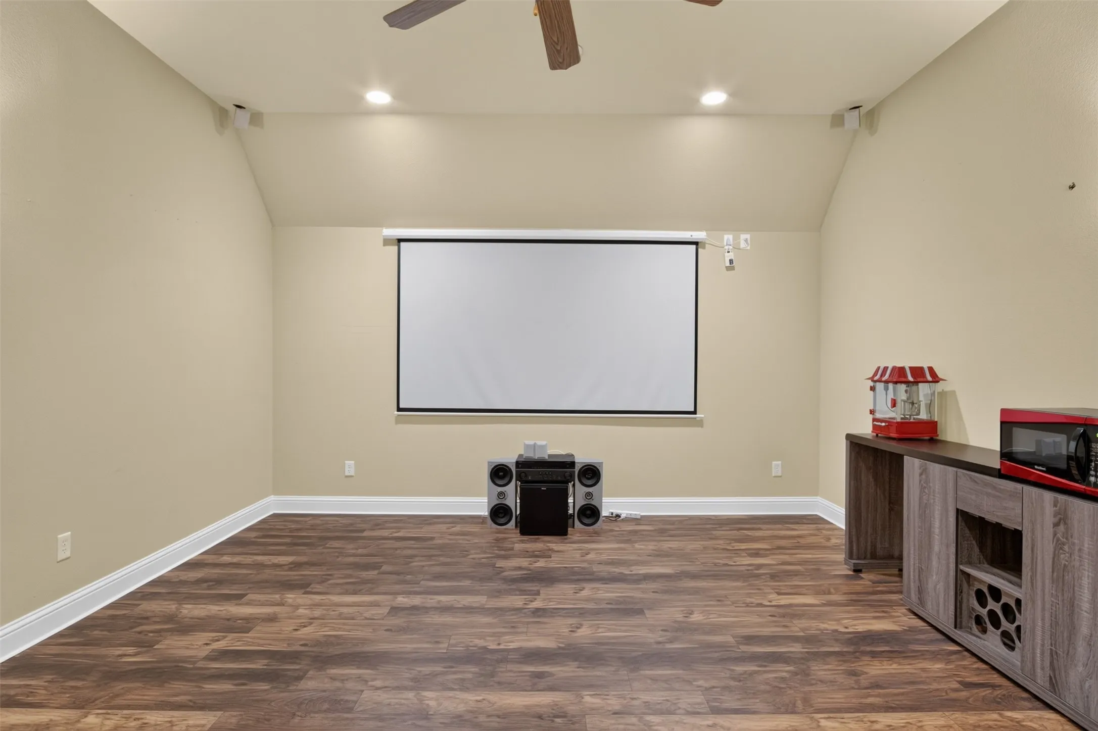 Media Room featuring wood-finish flooring, recessed lighting, and a mounted projection screen