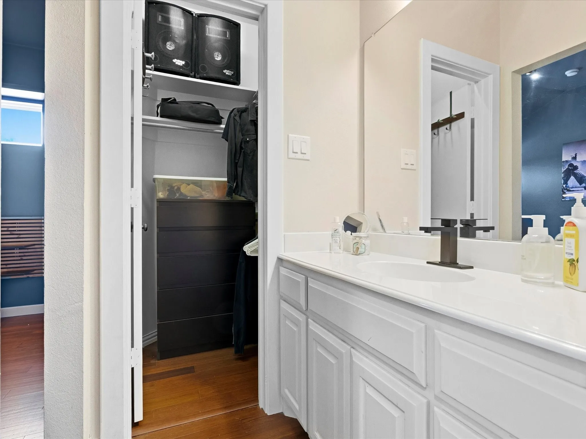 Vanity featuring a single undermount sink, a dark bronze faucet, and a large mirror
