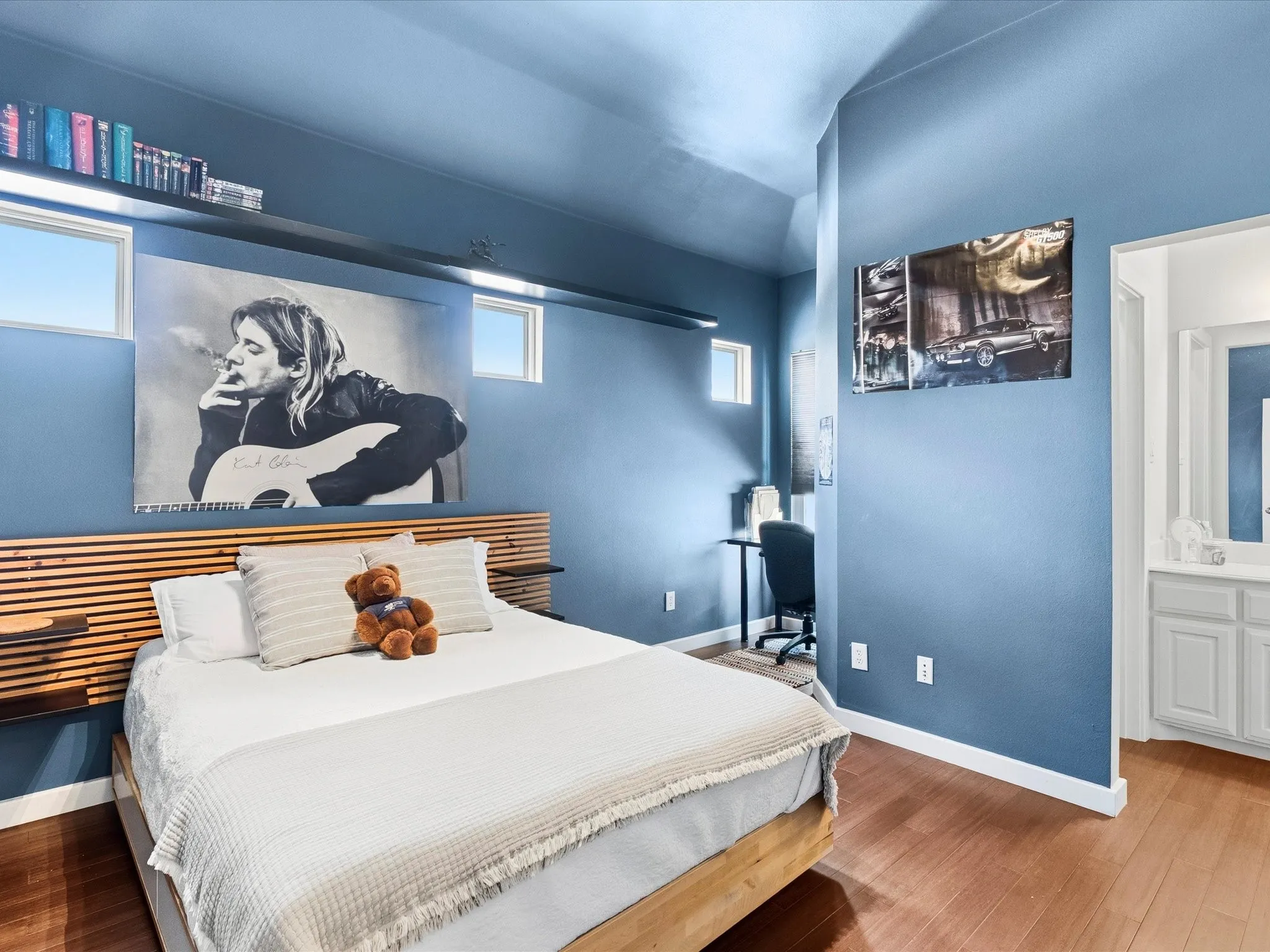 Bedroom with walk-in closet, updated Jack & Jill Bathroom, wood-finish flooring, light blue walls, and high ceilings