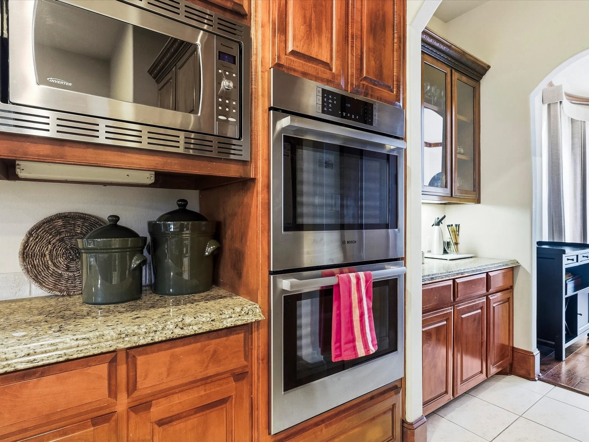 Stainless steel double wall ovens integrated into custom wood cabinetry