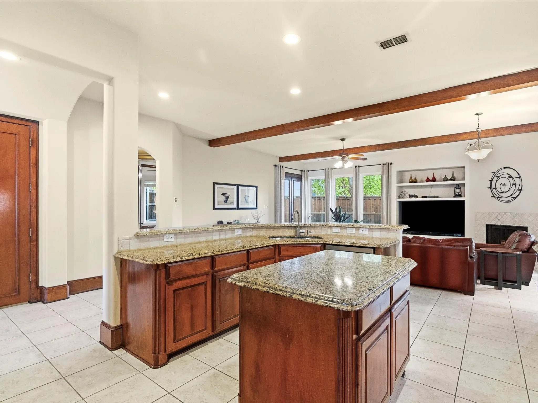 Kitchen island featuring granite countertops and wood cabinetry