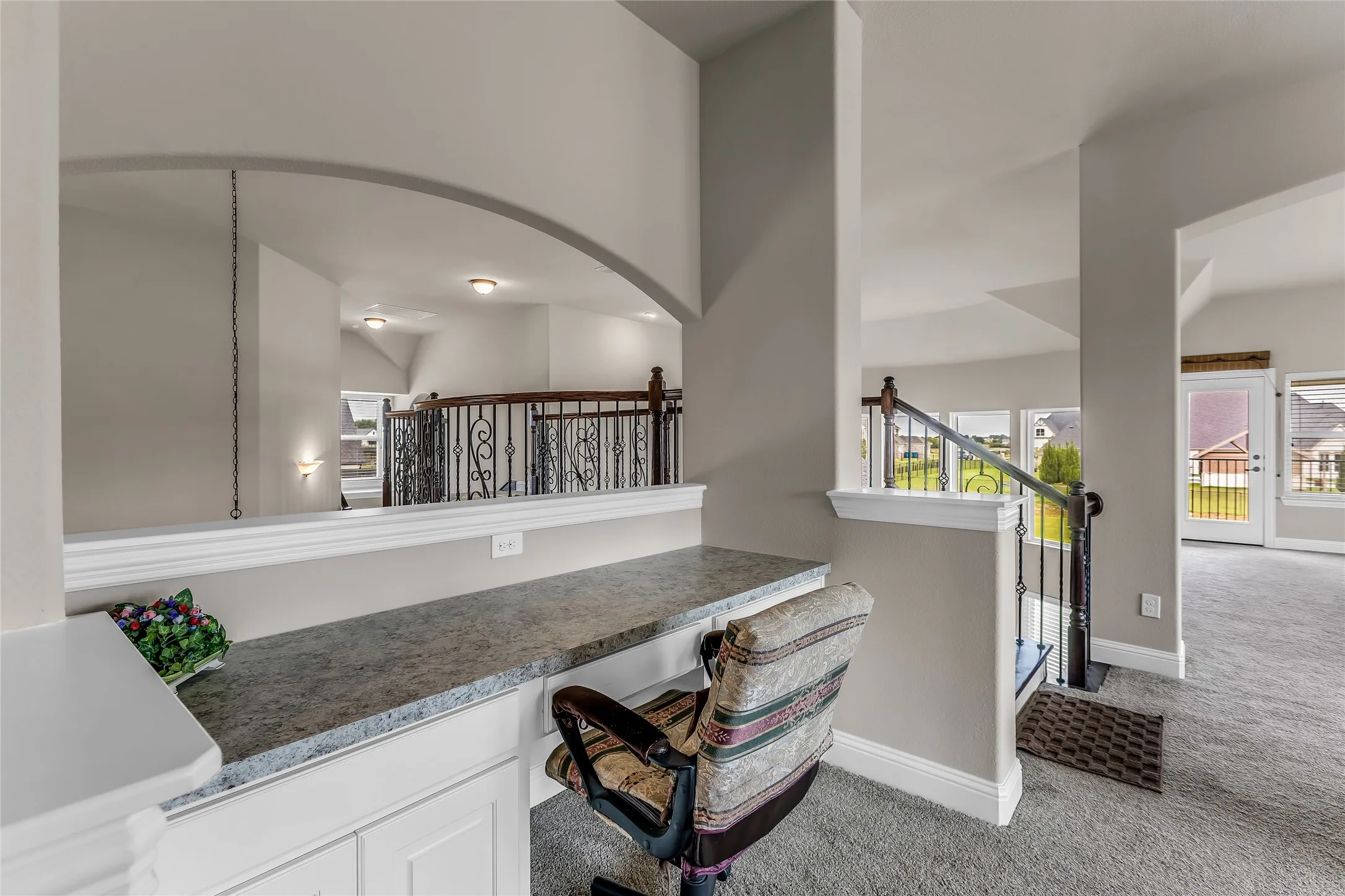 Built-in desk area featuring a speckled countertop and base cabinetry