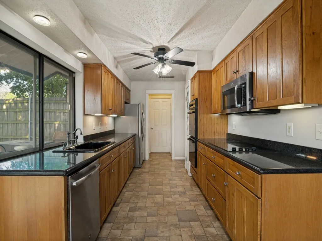 Efficient kitchen features loads of storage, double oven, sink overlooking the back yard and built in microwave.