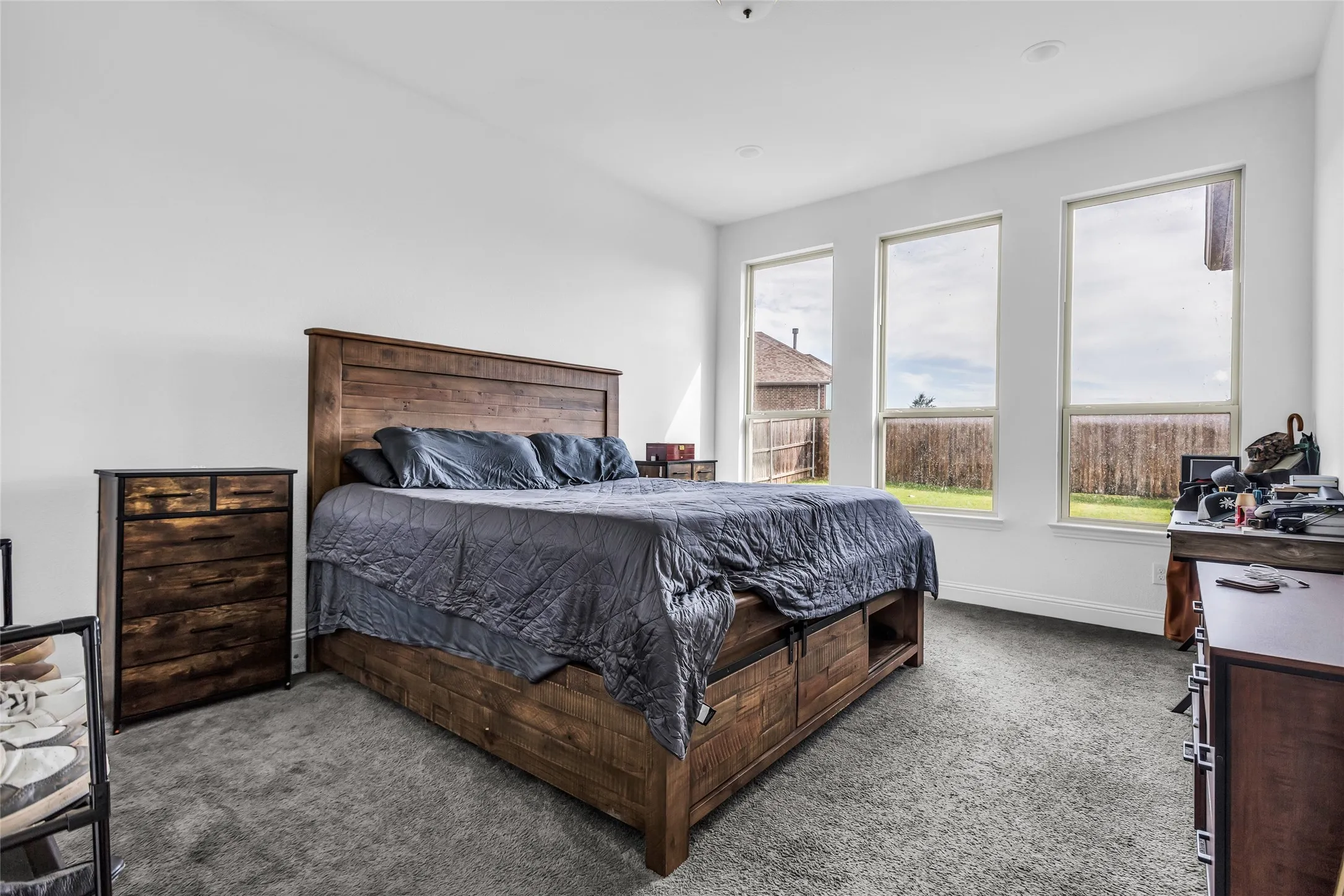 Carpeted bedroom featuring baseboards