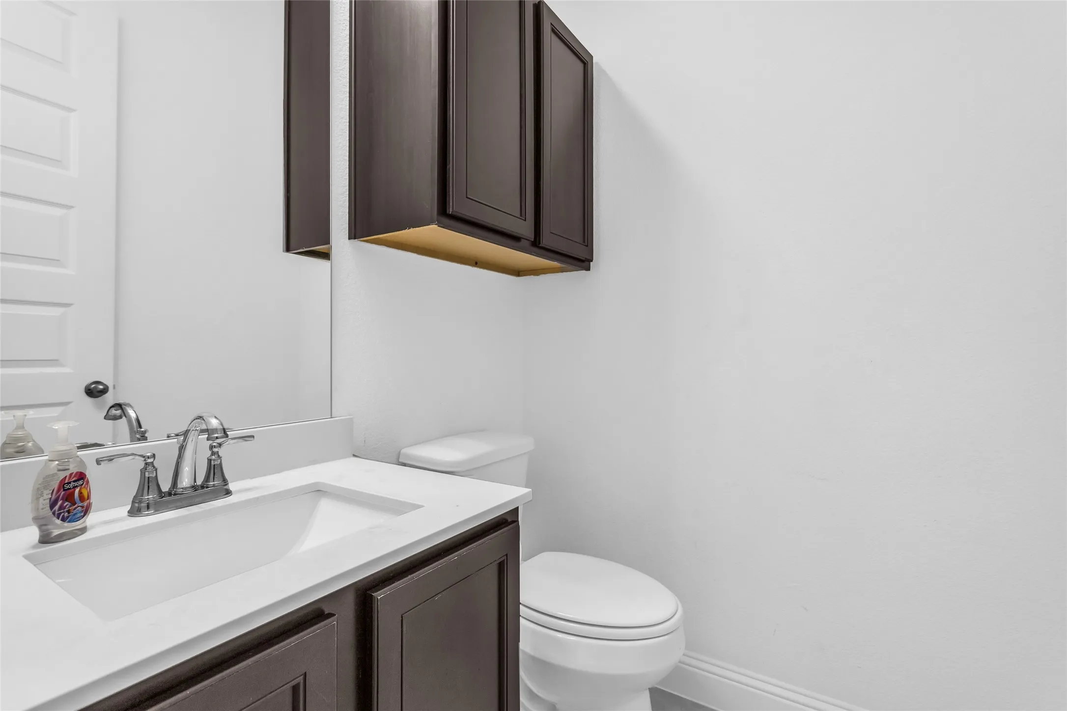Half bathroom with vanity and toilet