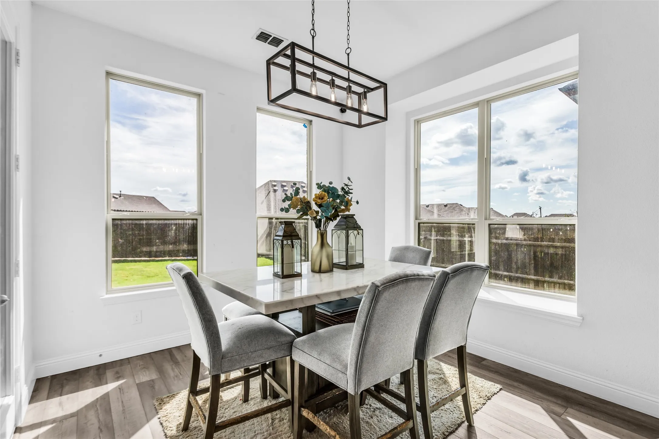 Dining area featuring wood finished floors and plenty of natural light