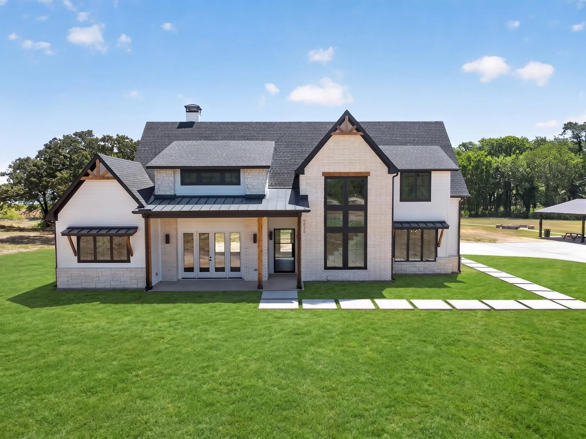 The warm combination of white brick with raw cedar timbers creates a welcoming, sophisticated look.