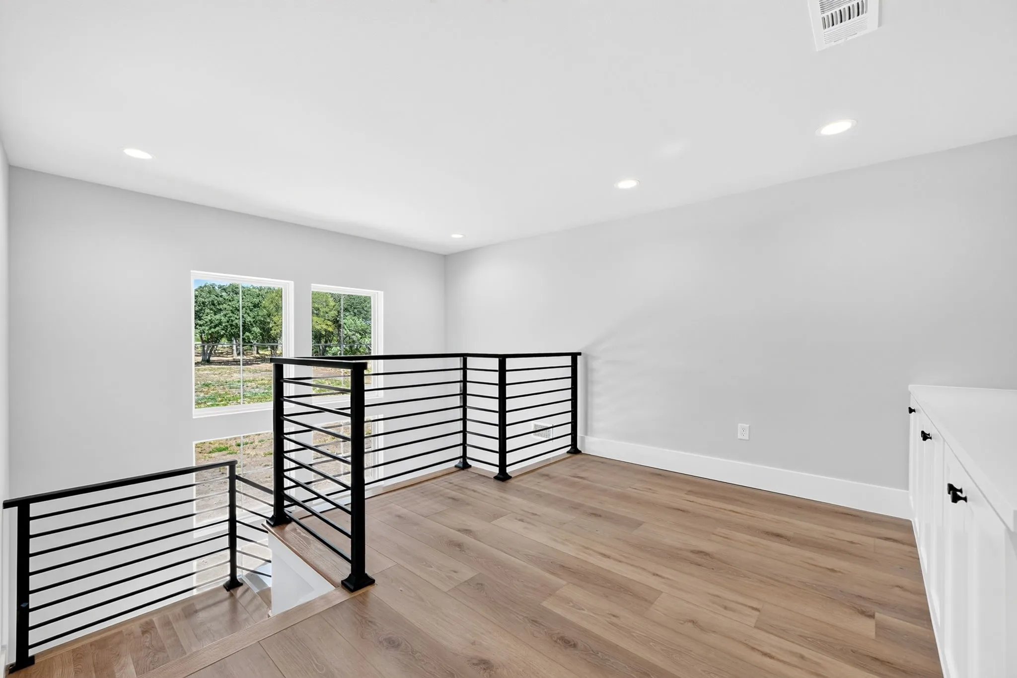 Upper level loft that features built in cabinetry.