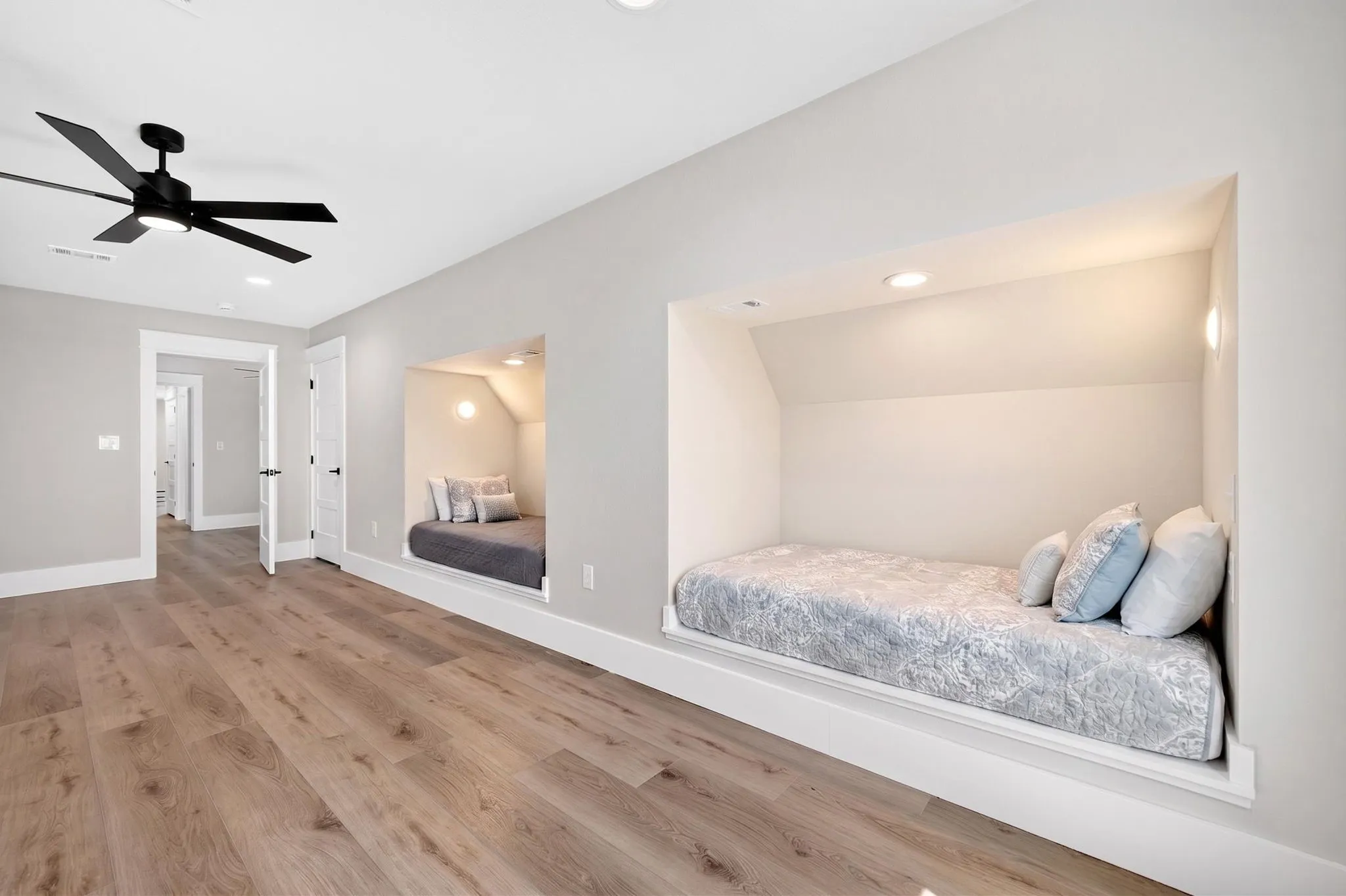 Ultimate destination for large families: Custom-built-in bunk room equipped with four distinct beds.  Each nook features a private sconce light and dedicated electrical outlets.