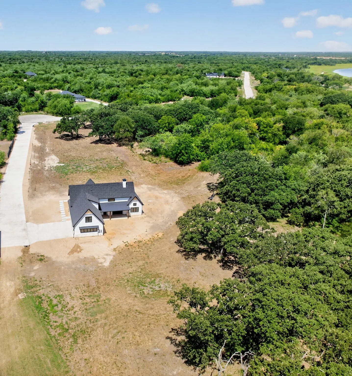 1.56 acres.  Stunning aerial picture showcasing the magnificent 1.56 acre lot surrounded by mature trees.