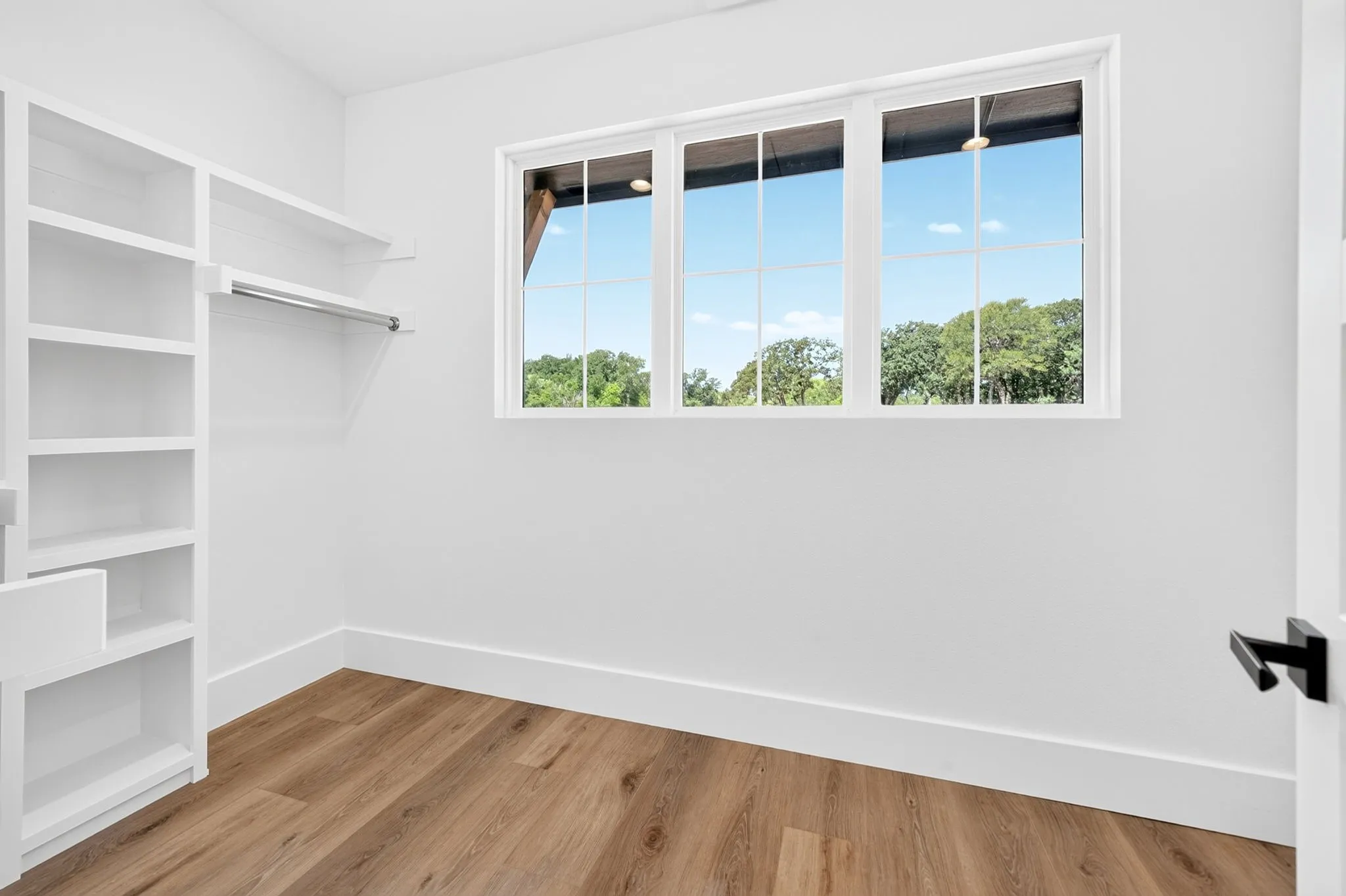 Master closet with expansive windows to allow in natural light.