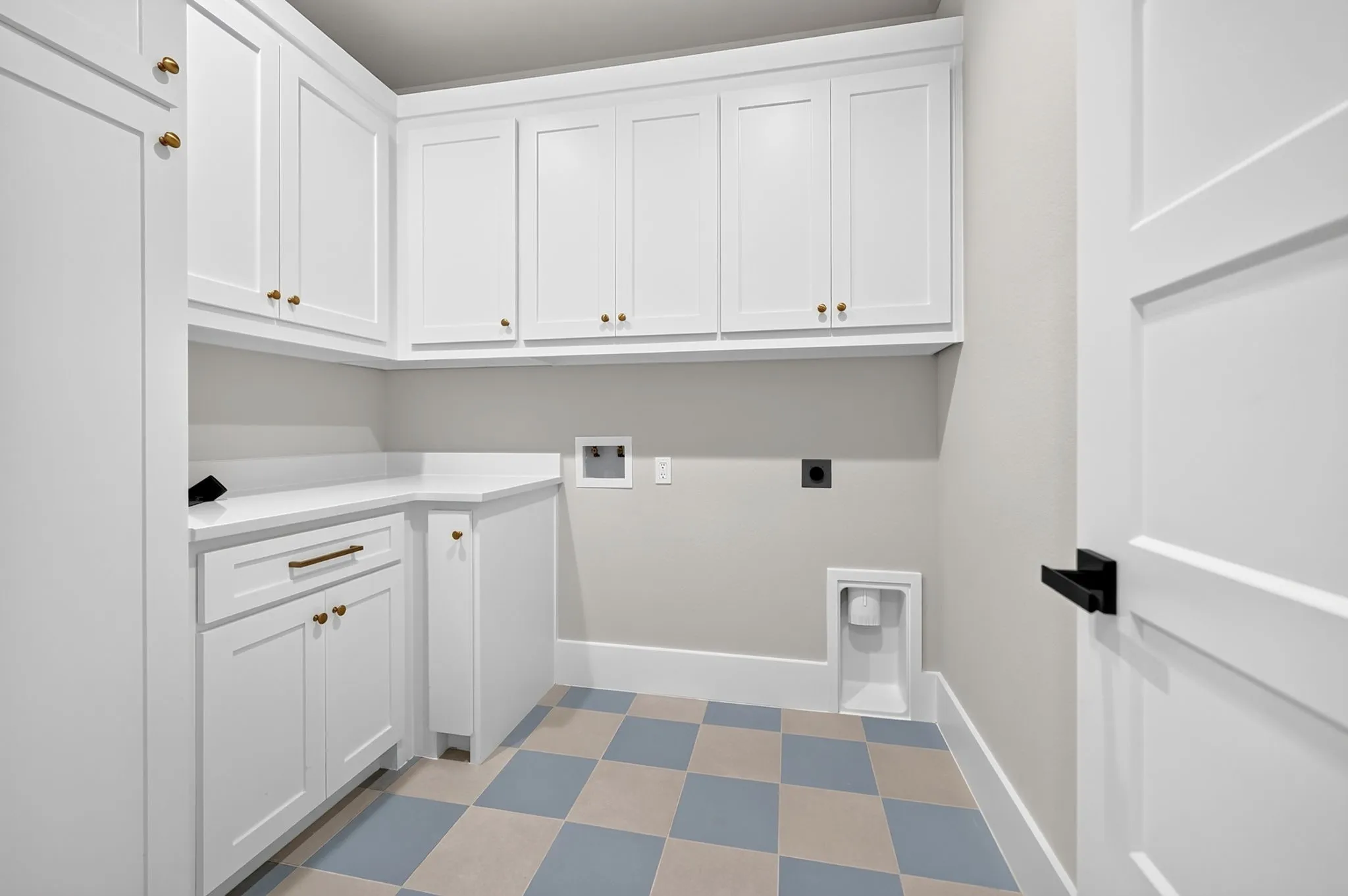 First floor laundry room with extensive cabinetry. Second floor also has stackable washer and dryer designated area.