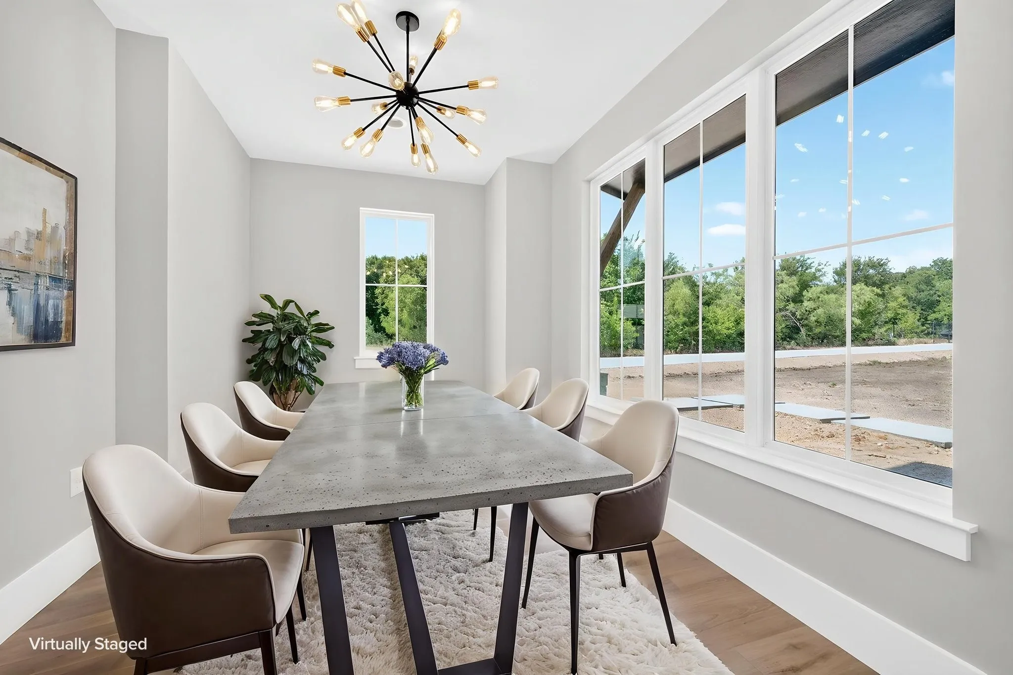 Sun-drenched home office or dinning room featuring expansive windows that invite abundant natural light.