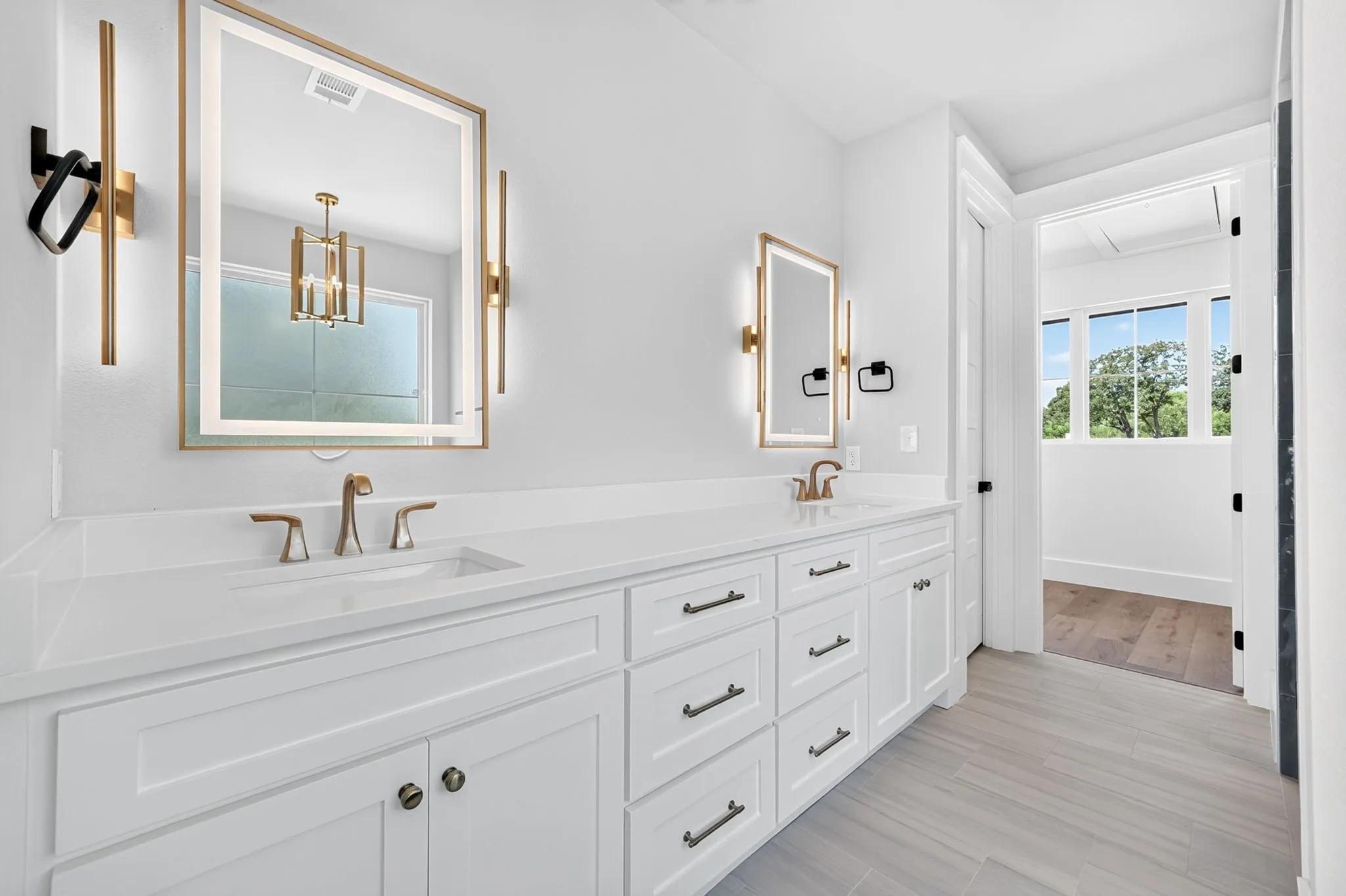 Spa master bath featuring double vanity with premium finishes, anti-fog LED mirrors with integrated defrost technology.
