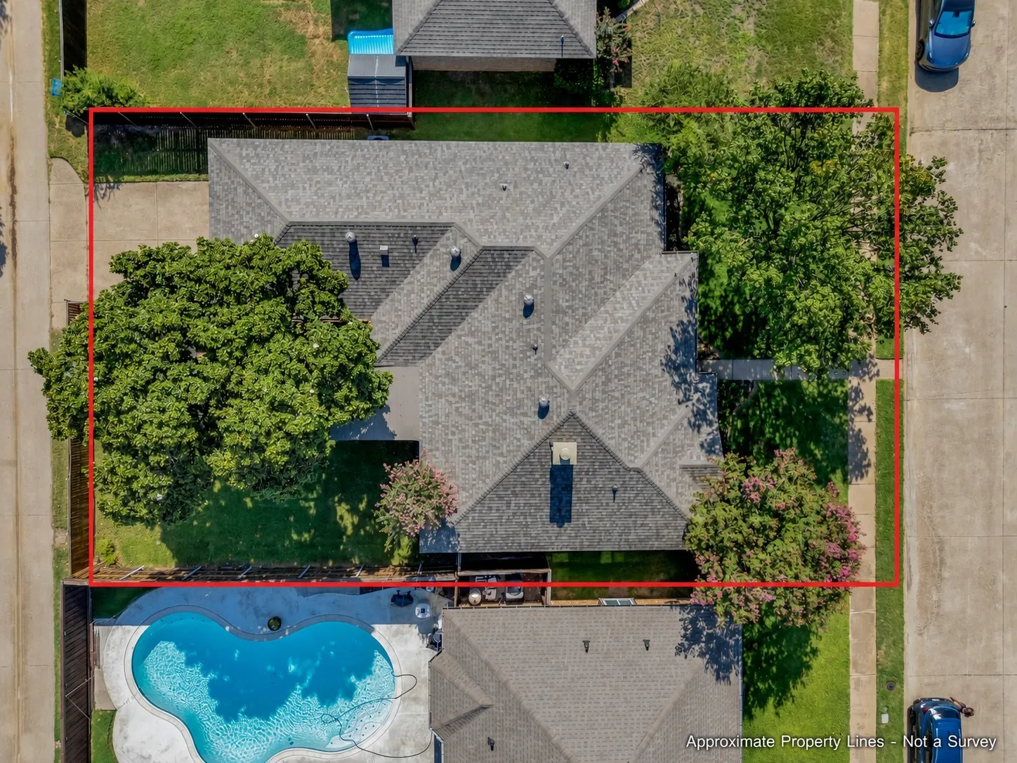 Aerial view showcasing a residential property with an asphalt shingle roof