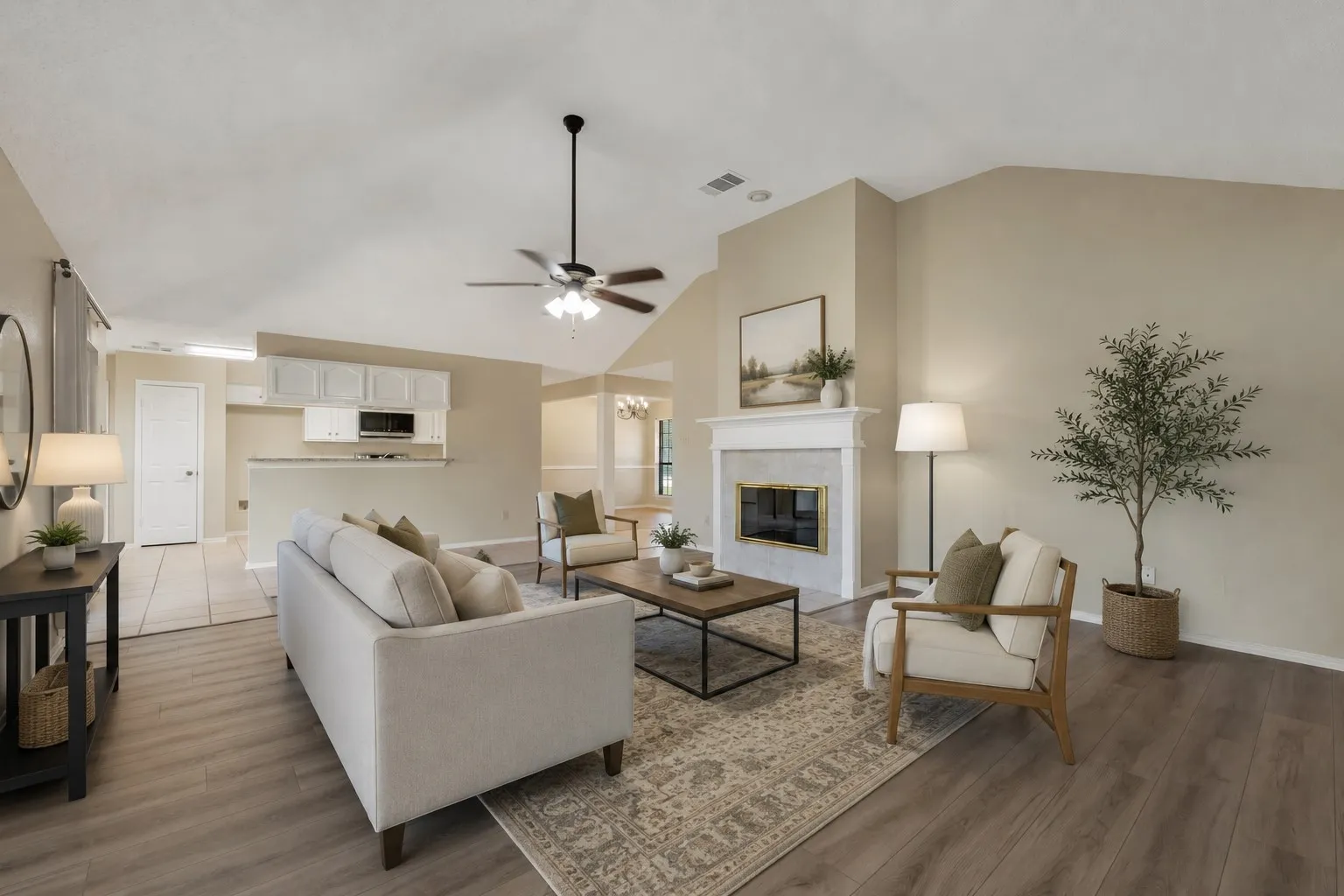 Spacious living area featuring vaulted ceilings, a ceiling fan, and Luxury Vinyl flooring -virtually staged to illustrate possible furniture placement.