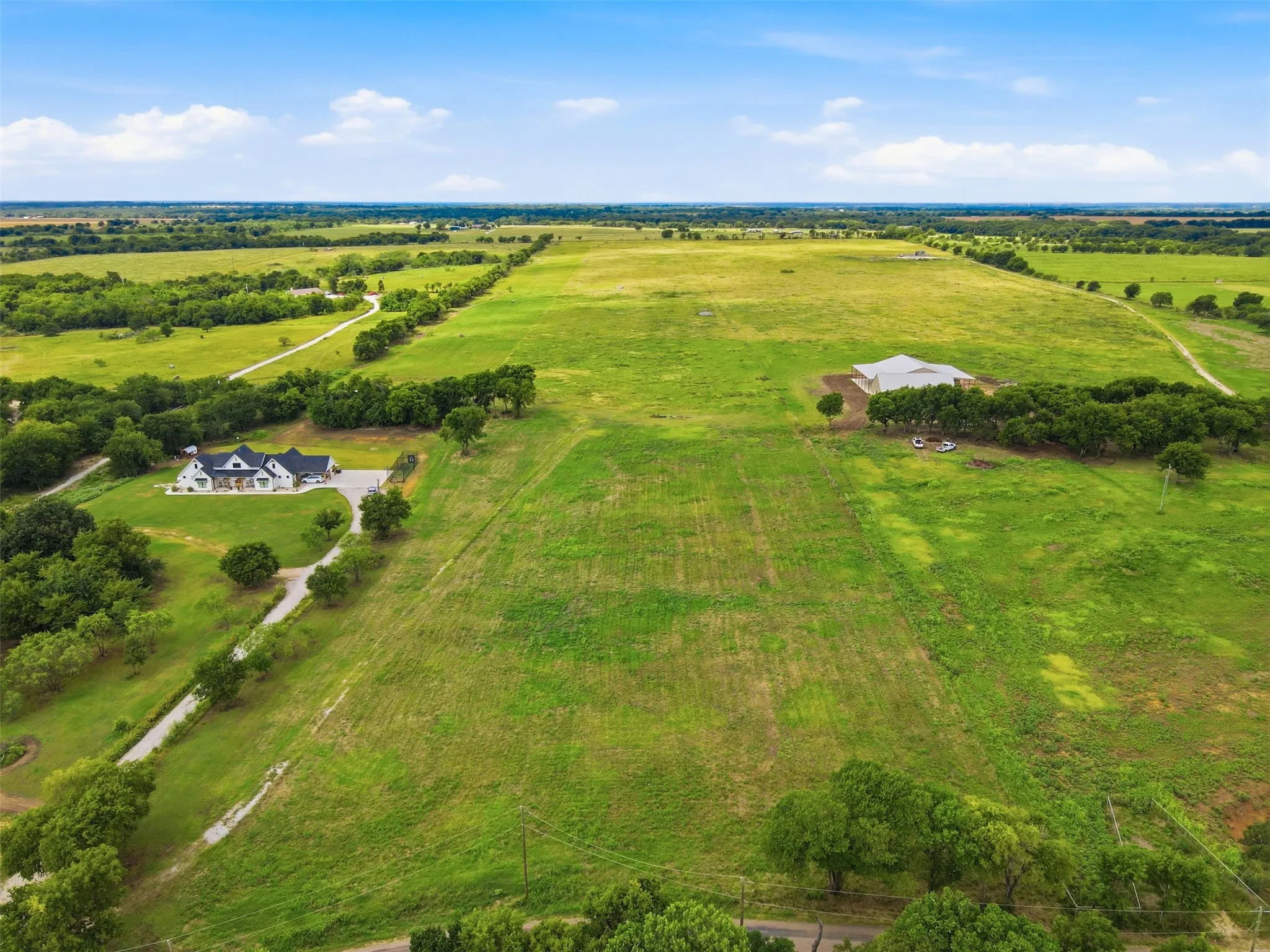 Smaller drive to the left coming in property.  Property is fenced to the right.