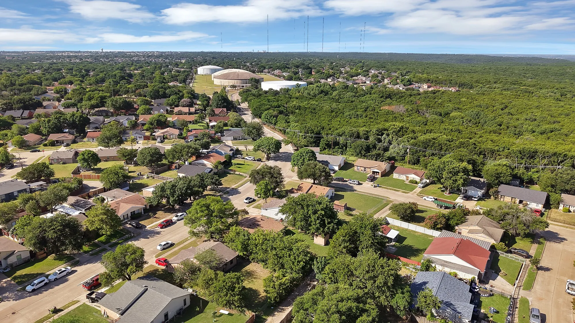 Residential neighborhood featuring mature trees and a clear sky