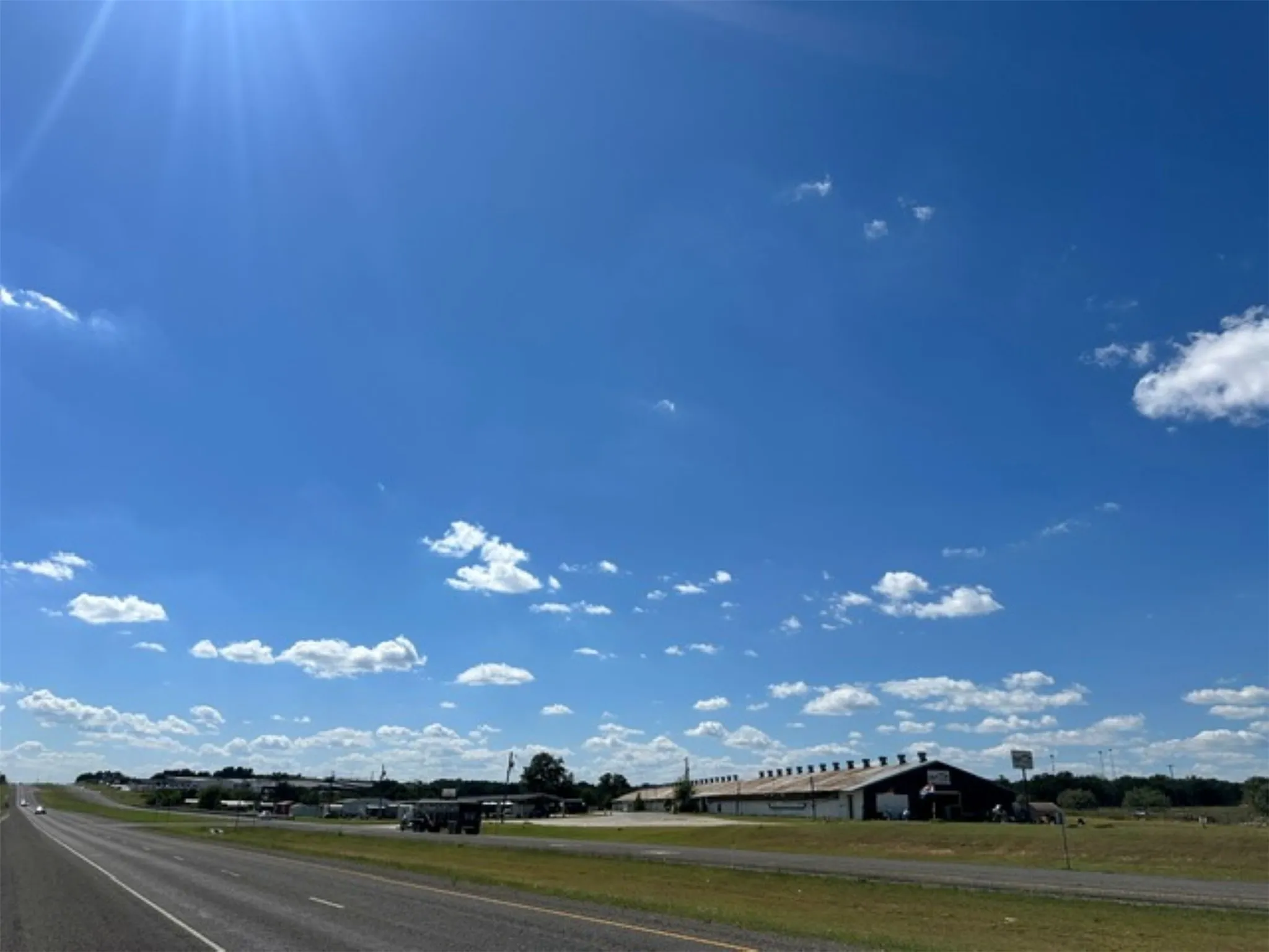 View of Main Building from one end of the property. Photo taken from across HWY 377