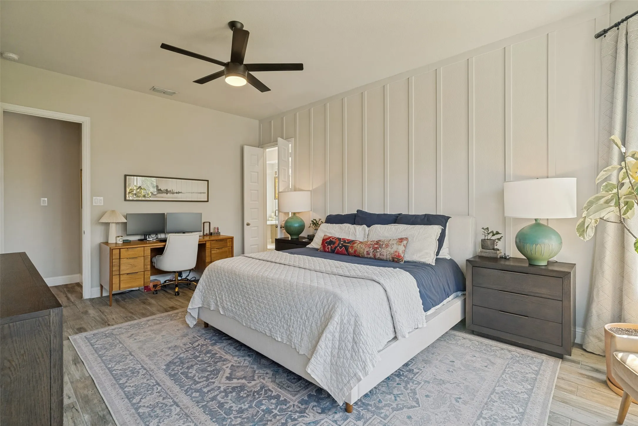 Bedroom featuring board and batten accent wall, wood-finish flooring, ceiling fan, and recessed lighting