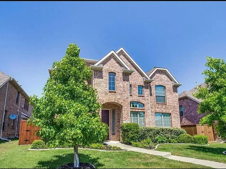 Traditional brick facade featuring multiple gables and arched windows