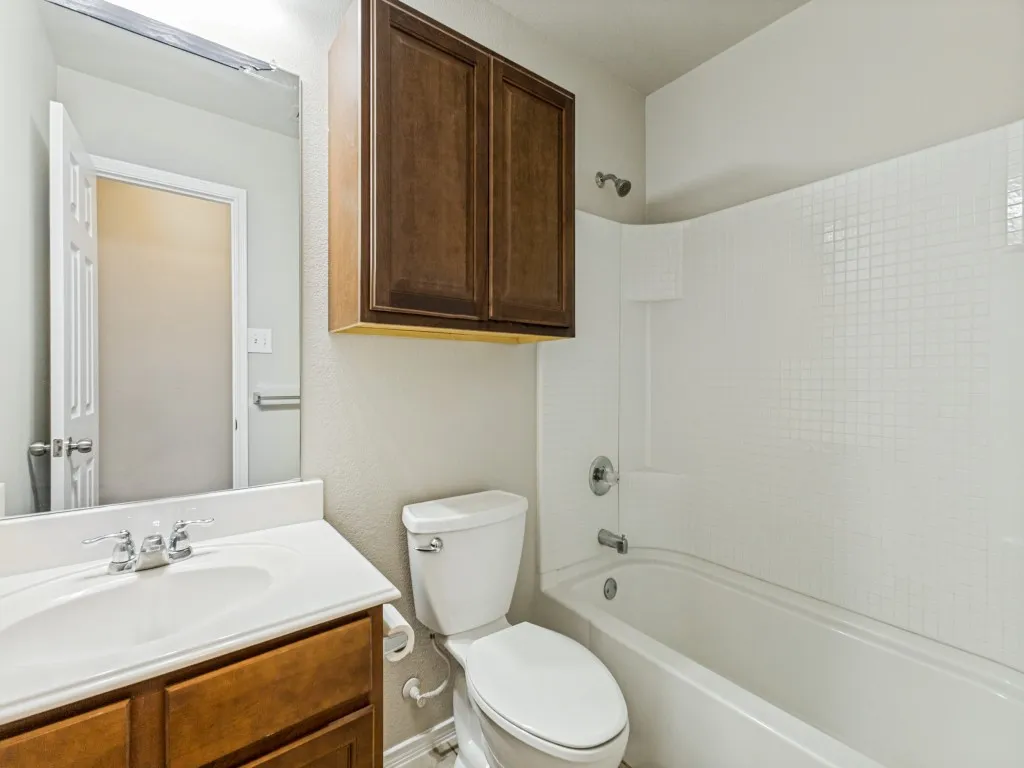 White tile-surround bathtub and shower combination
