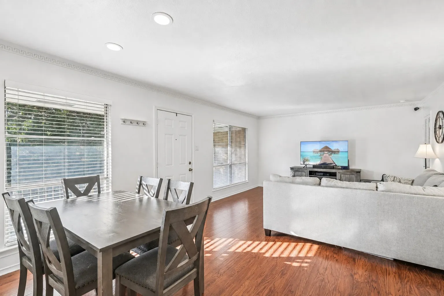 Open-concept living space with wood-finish flooring