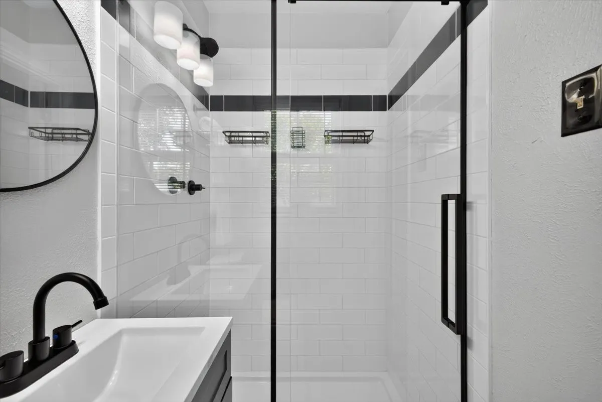 Walk-in shower with tile surround and glass enclosure