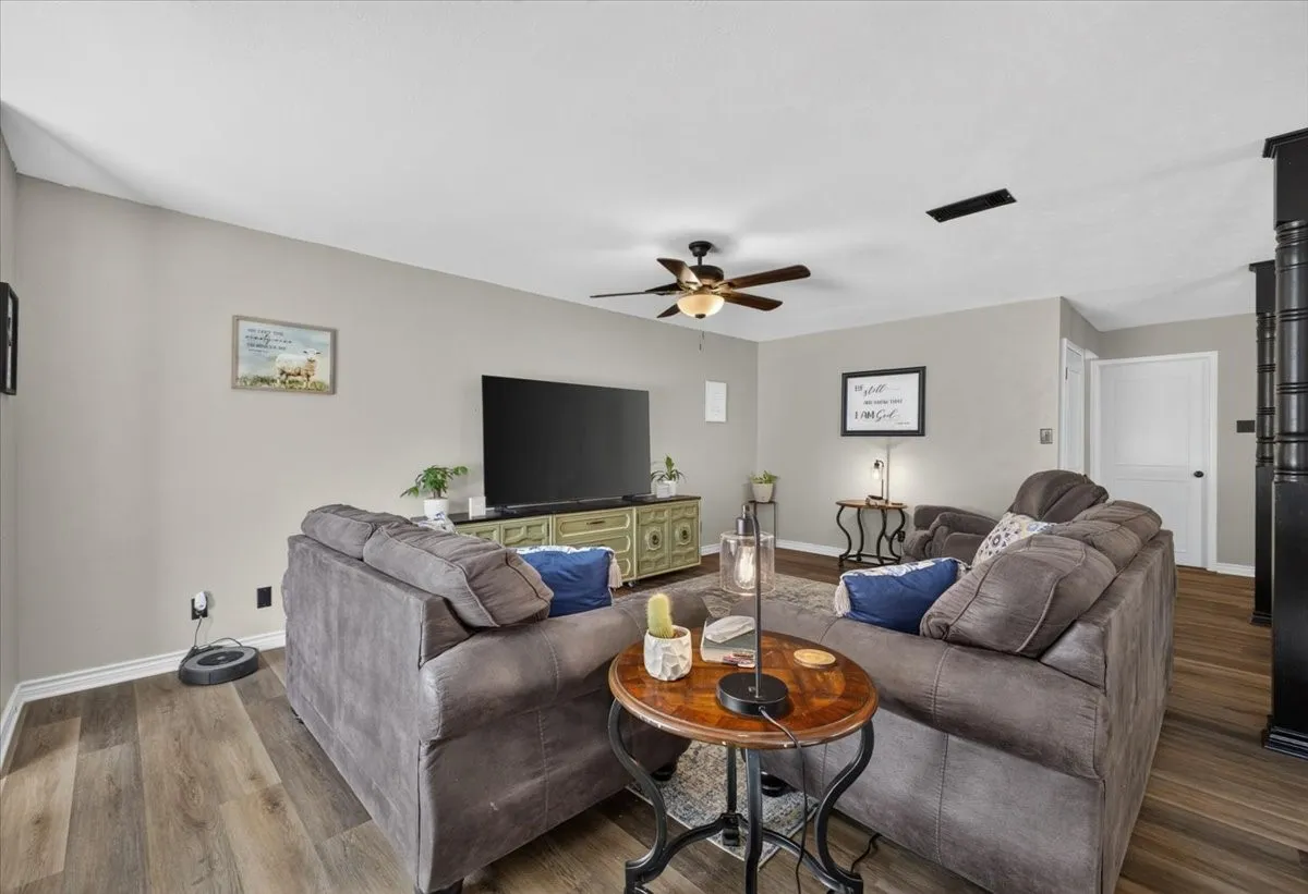 Main living area with updated flooring and easy flow to dining area