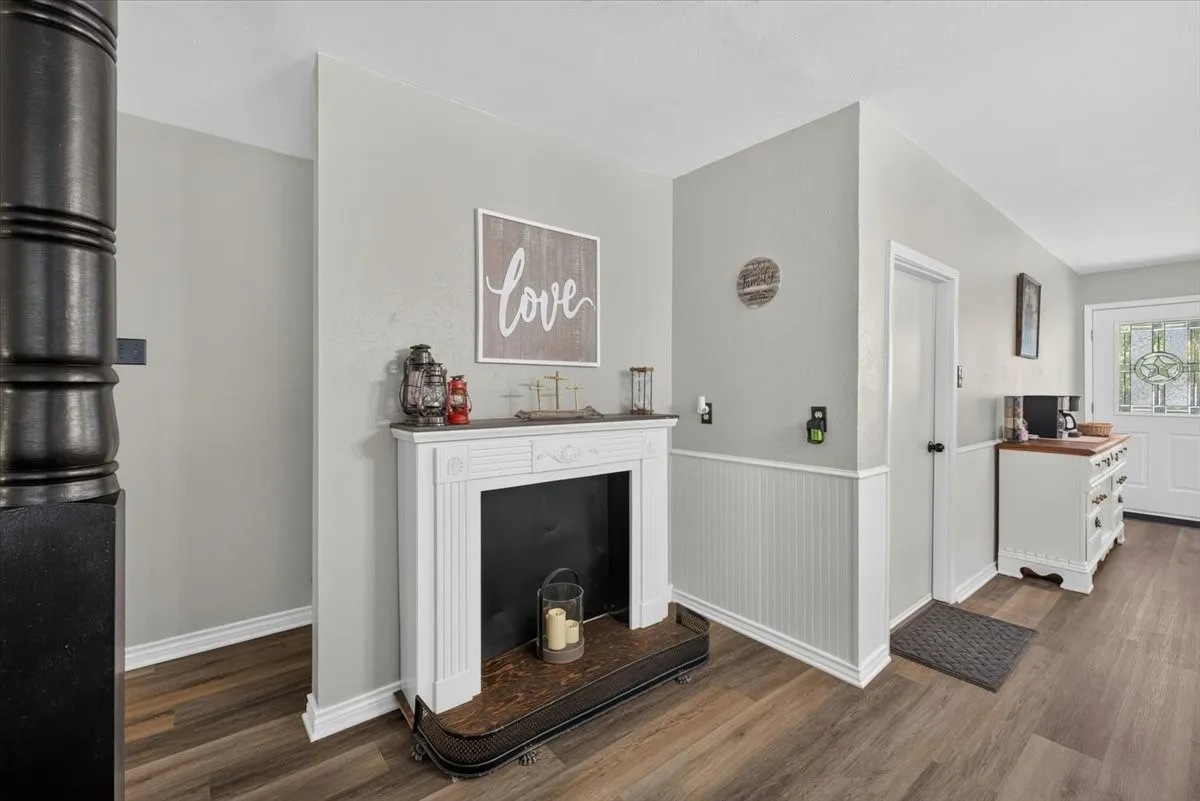 Decorative fireplace near dining area with access to garage/workshop space