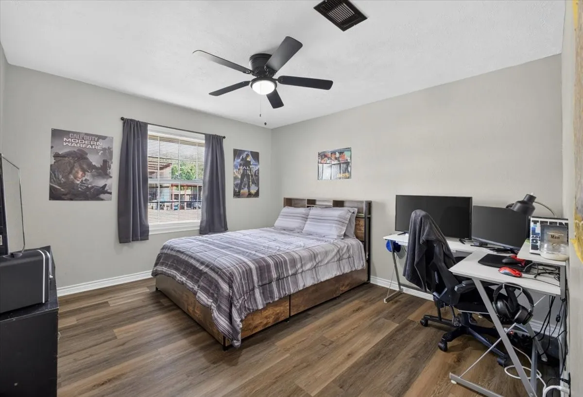 Secondary bedroom with updated flooring and room for desk or study space