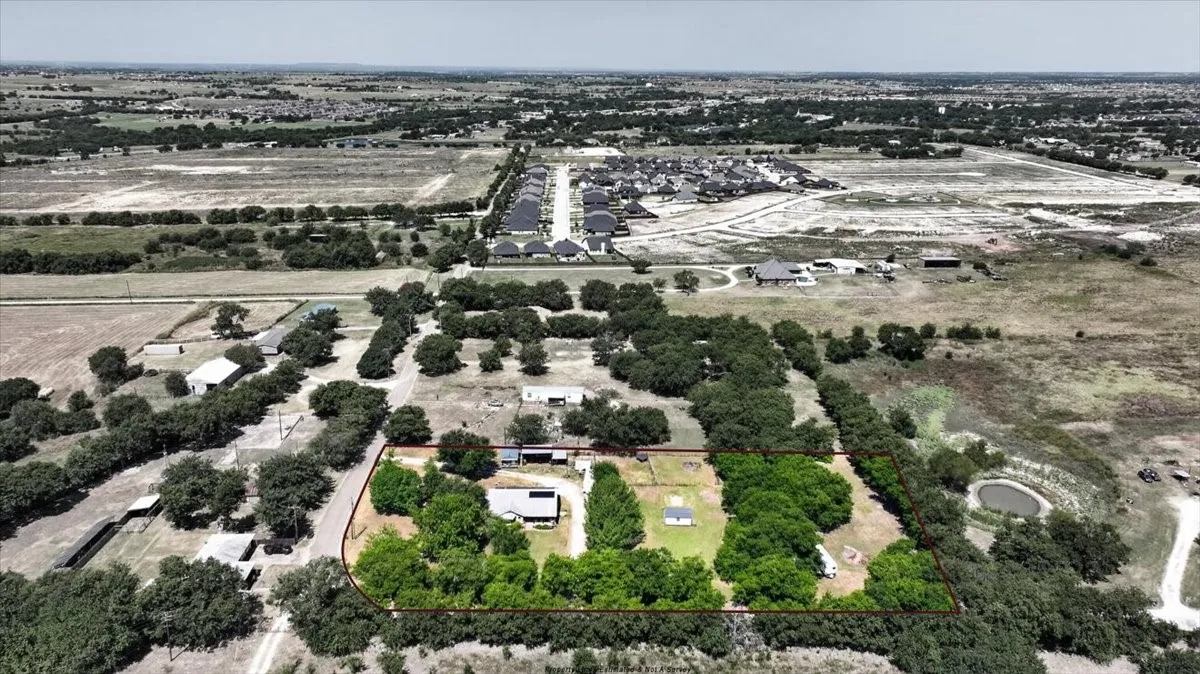 Aerial view with estimated property lines showing nearly 2-acre property setting