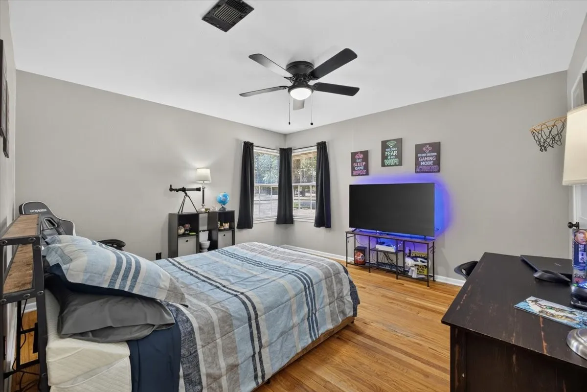 Secondary bedroom with original hardwood flooring and natural light