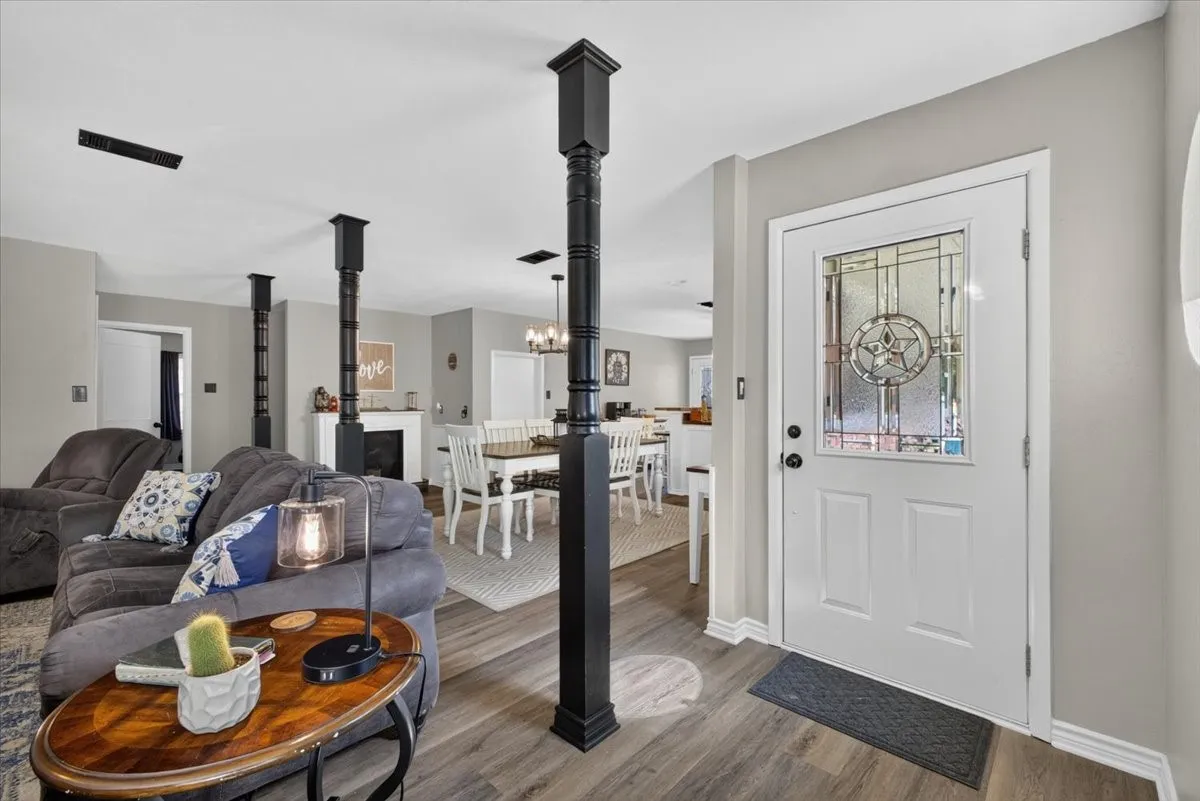 Entry opens to living, dining, and kitchen areas with updated flooring