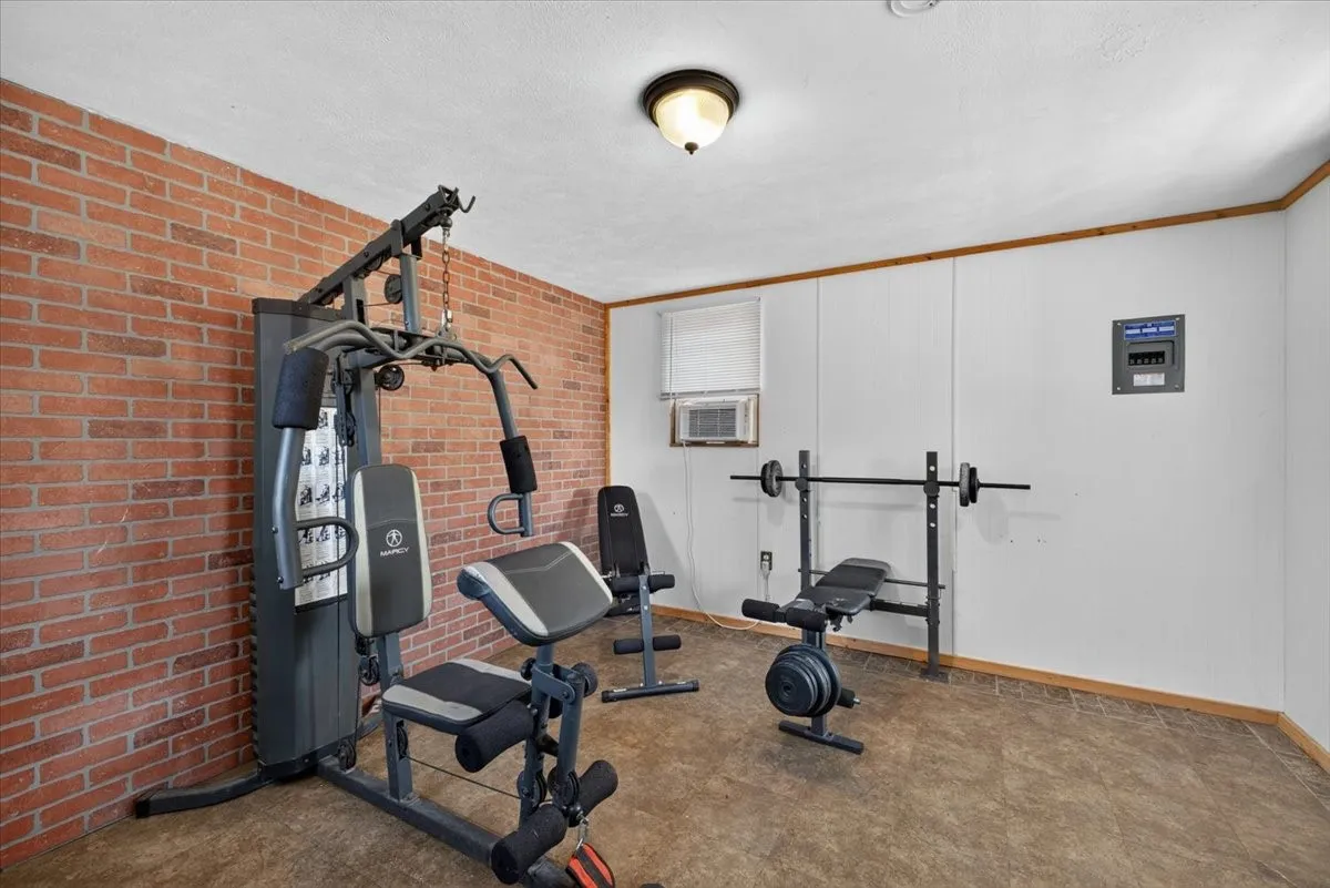 Interior of detached studio/workshop with electricity and window unit, no plumbing