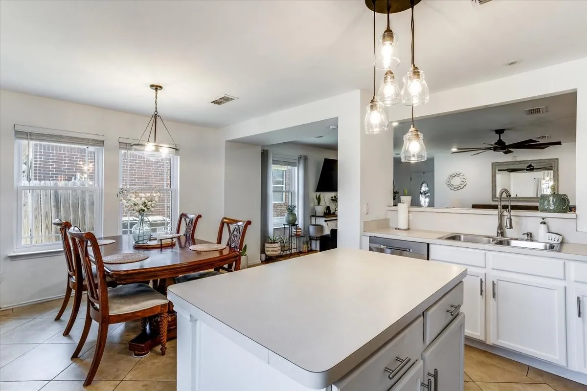Kitchen featuring a central island with light countertops, white cabinetry, and stainless steel appliances