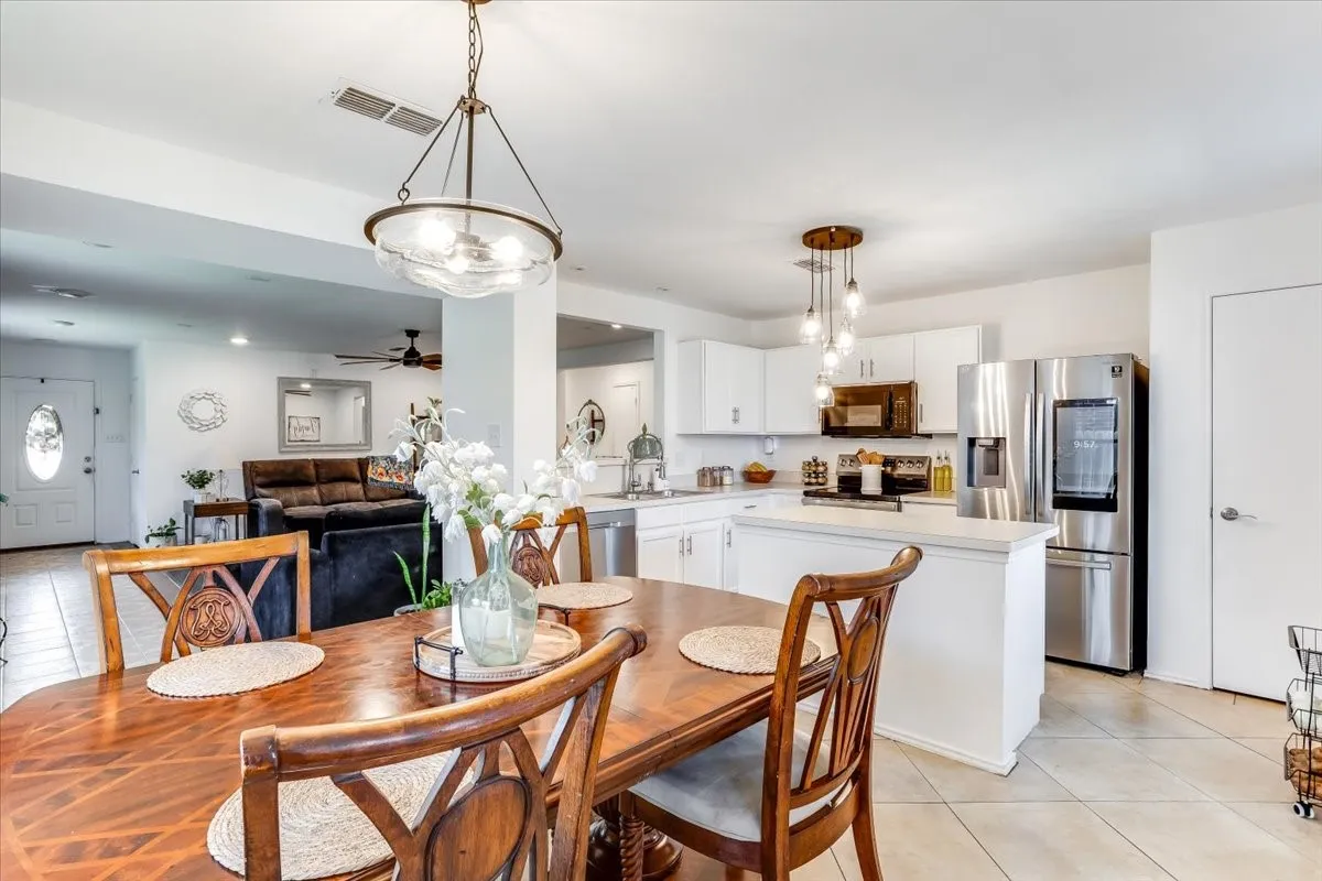 Open-concept living area featuring a formal dining space, kitchen, and casual living area