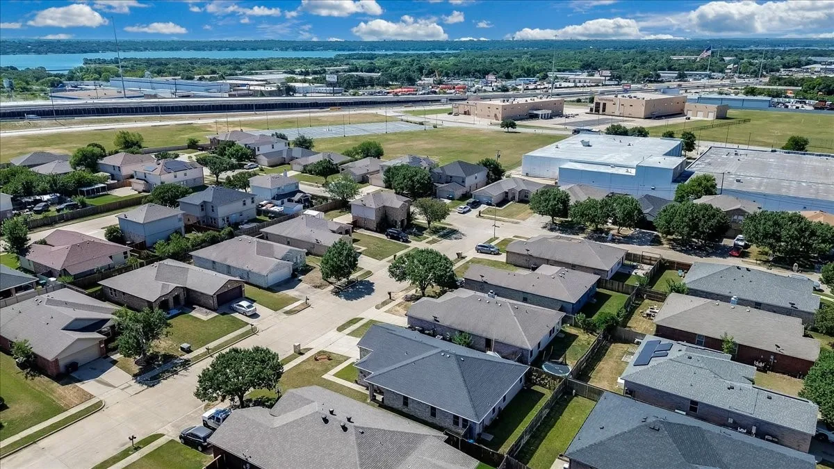 Residential neighborhood featuring single-story homes with shingle roofs and fenced backyards