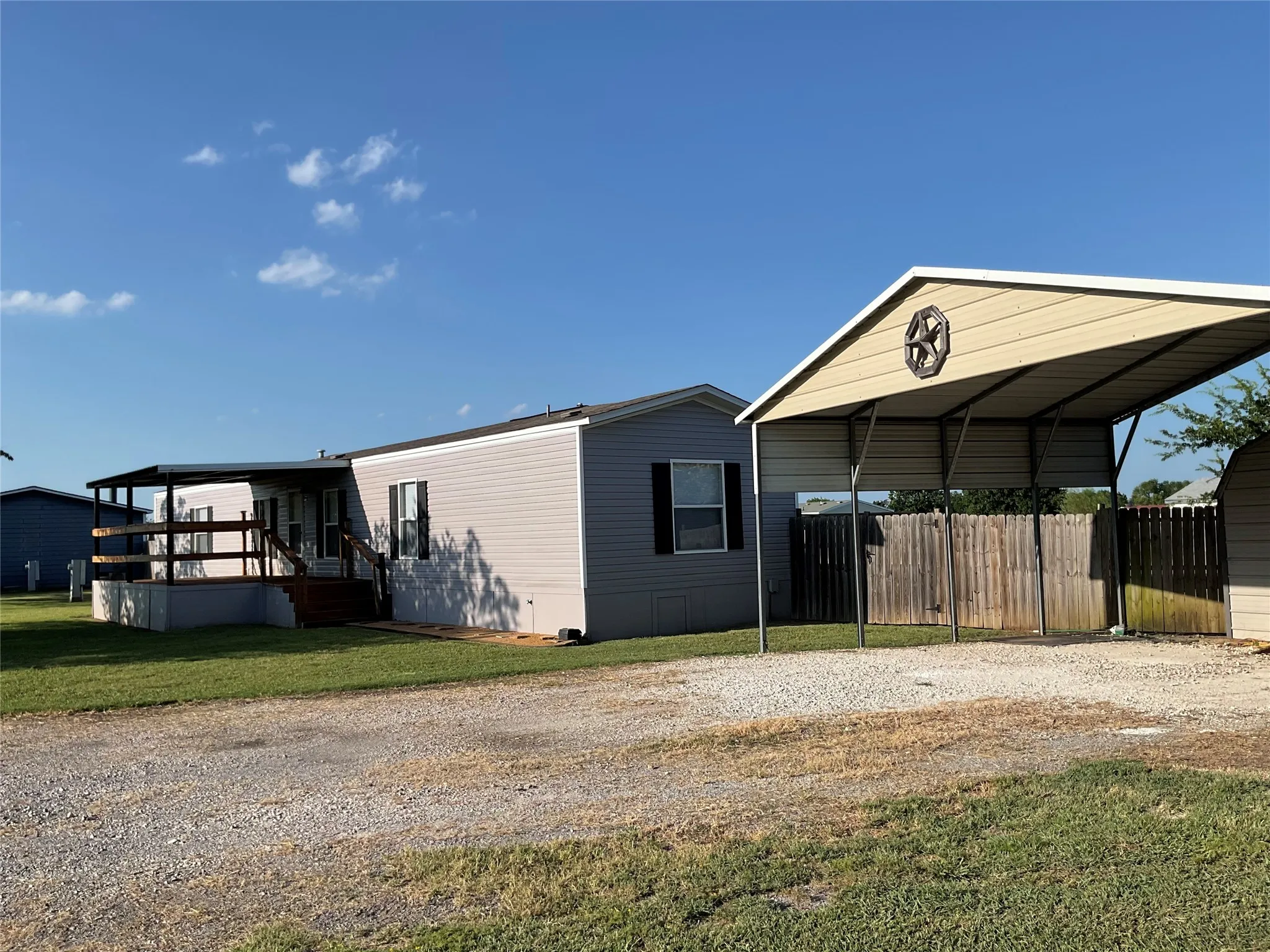Carport with storage building.
