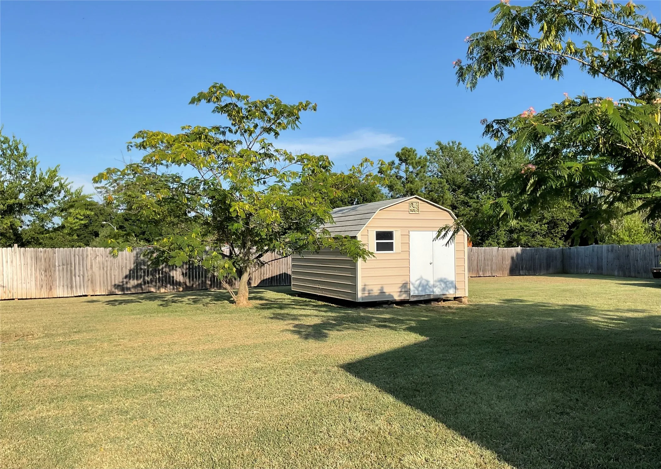 Outbuilding and privacy fence.