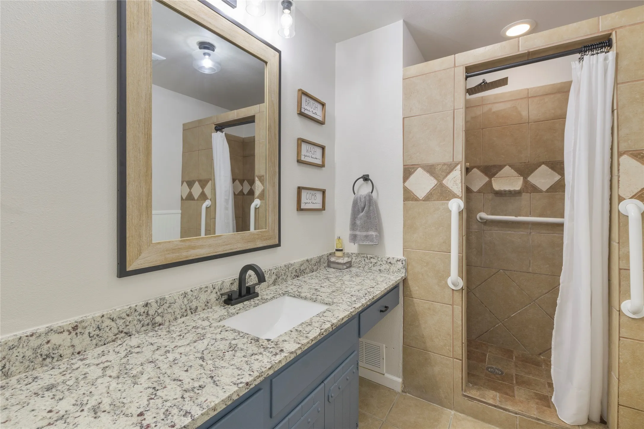 Bathroom vanity with granite-style countertop and undermount sink