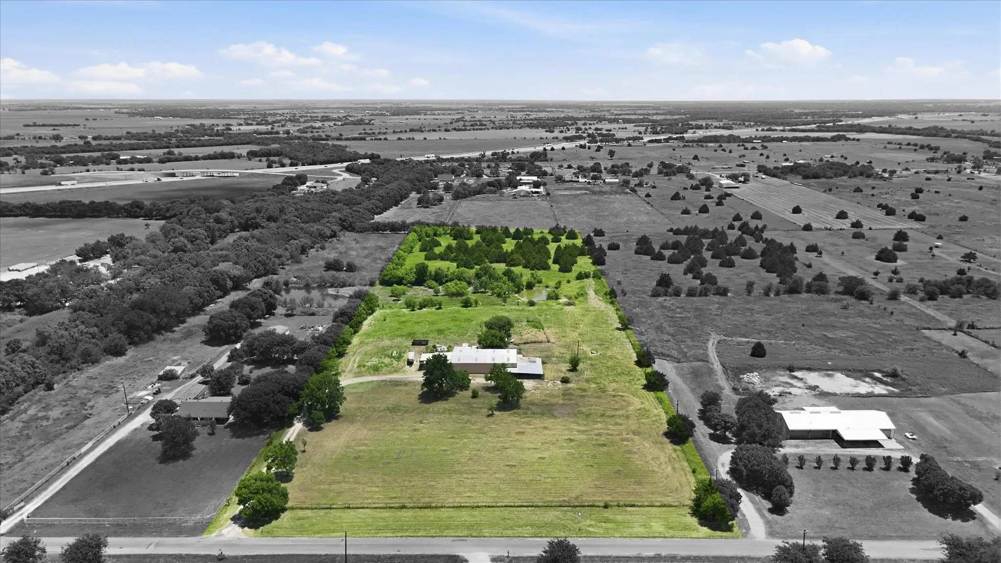 Expansive acreage featuring a mix of cleared land and mature trees