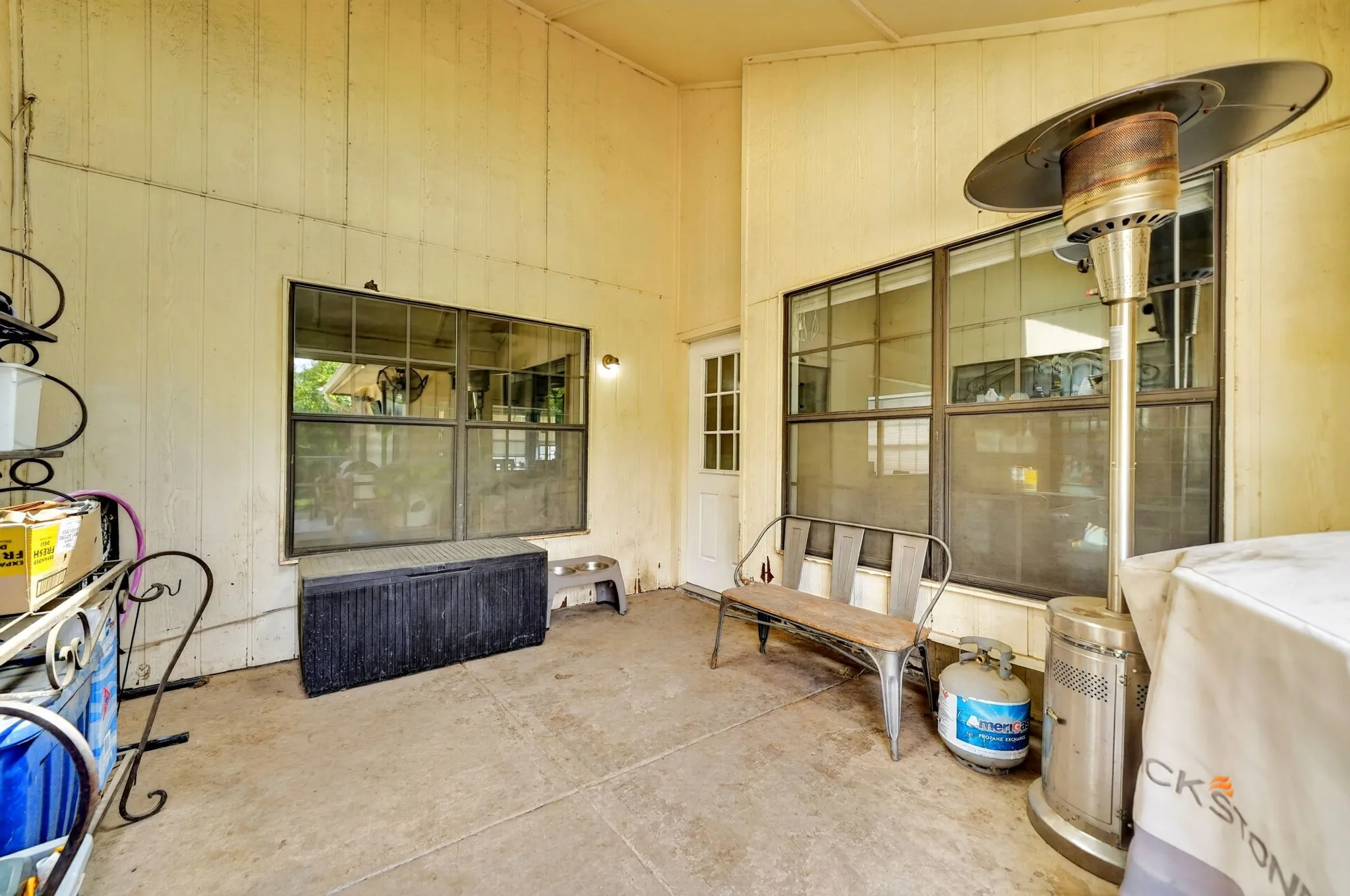 Covered patio framed by large windows with views into both the living and family rooms.