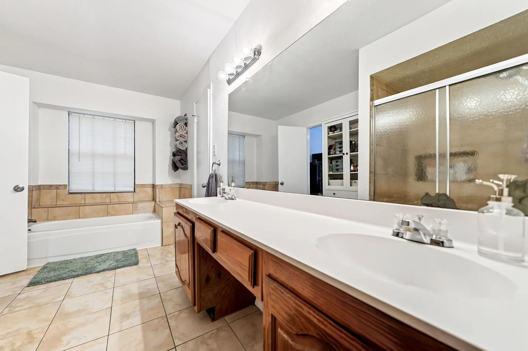 The spacious primary bathroom connects to the walk-in closet.