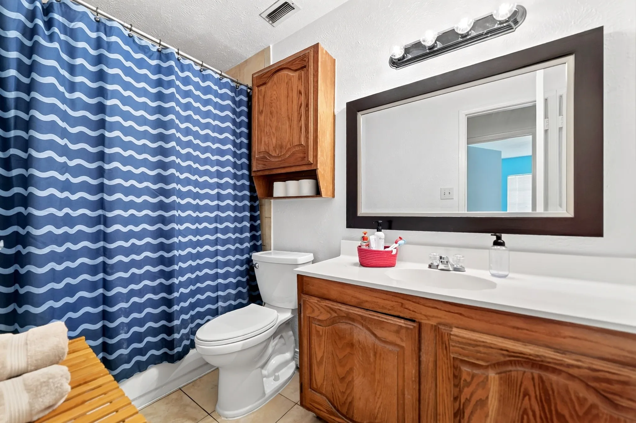 Second full bath conveniently located in the hallway that serves both guests and secondary bedrooms.