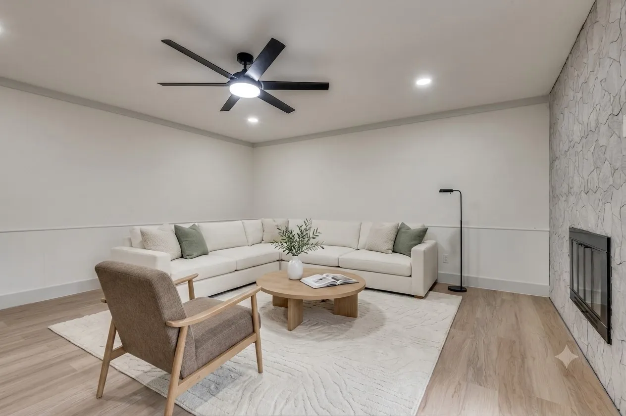 Virutally Staged 2nd Living area featuring a modern fireplace with a textured stone surround