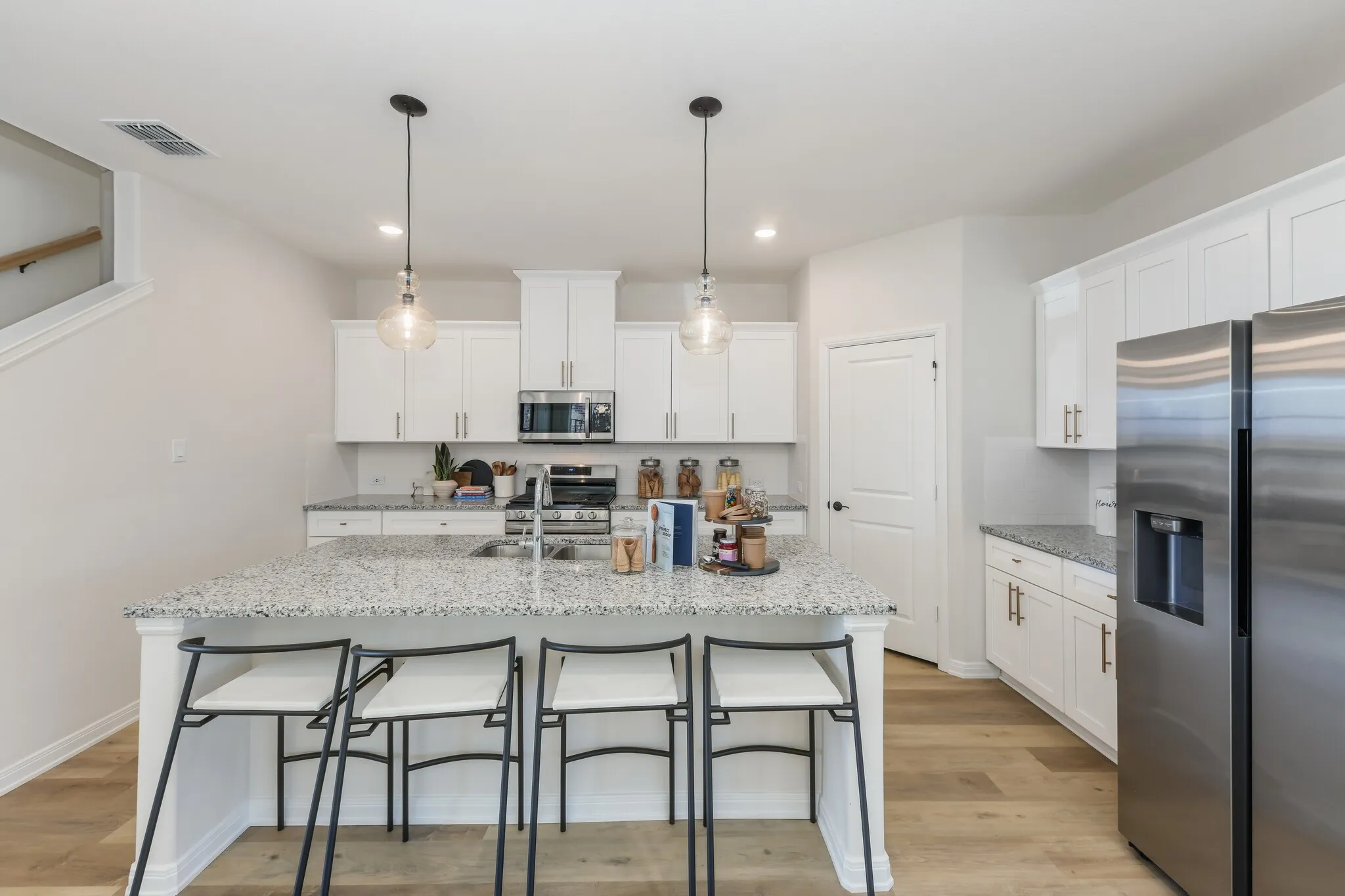 The nicely sized island is the hub of your new dream kitchen and the perfect place for friends and family to gather!