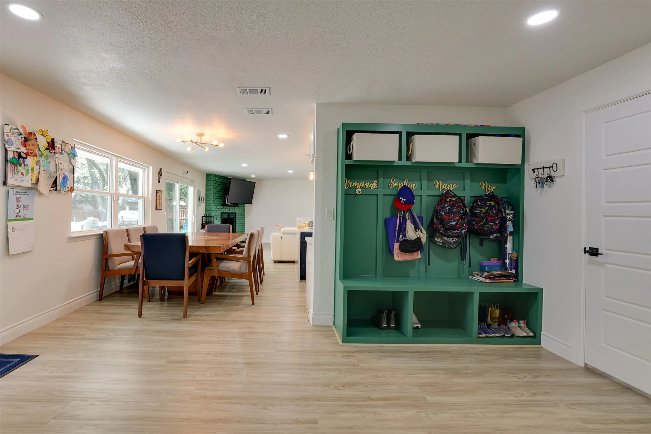 Built-in green storage unit with integrated hooks and cubbies