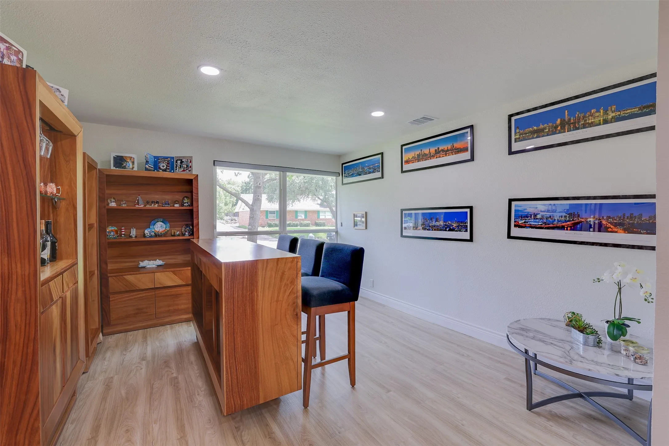 Built-in wood cabinetry and a wood-finish bar area with seating